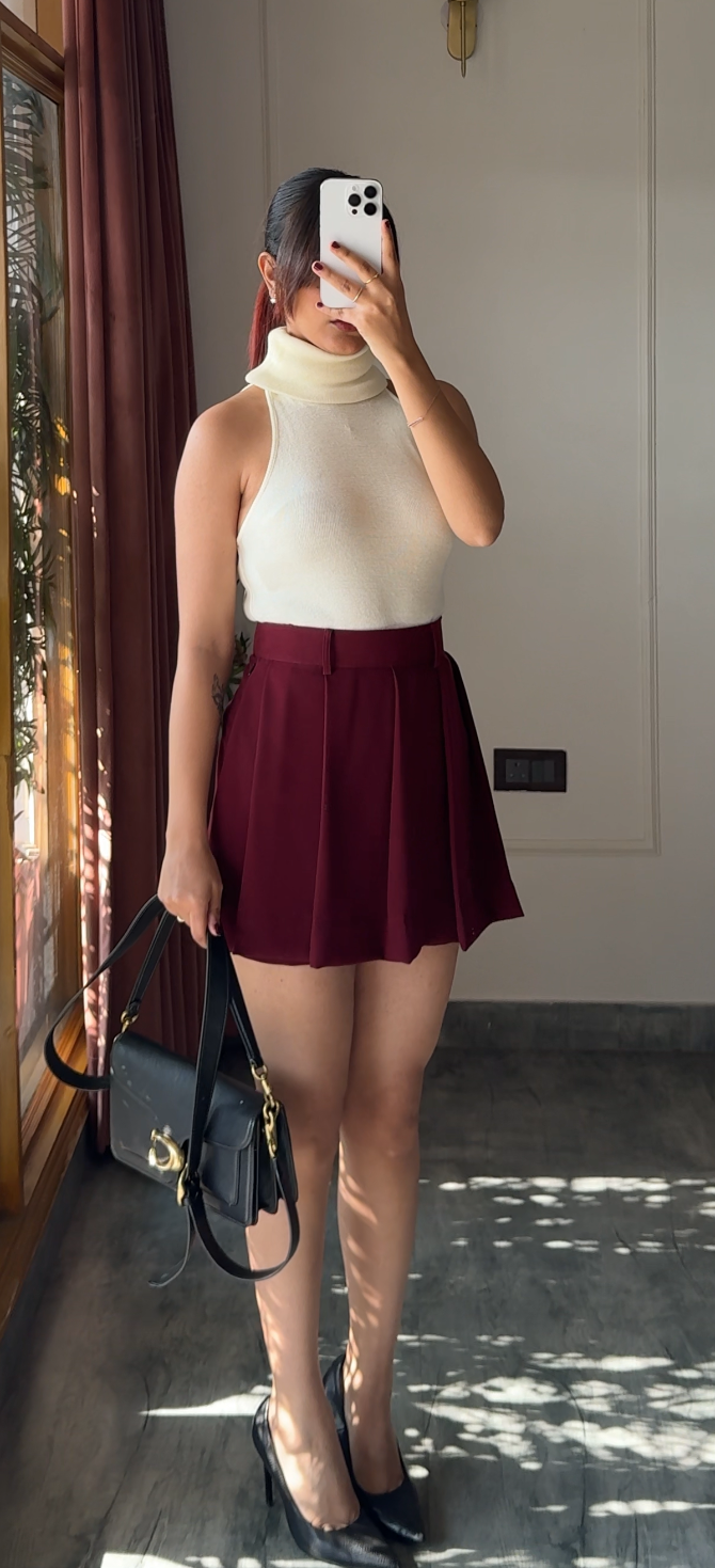 Girl wearing a red skort skirt that has box pleats and tailored fit in size 26 for valentine's day and other celebrations outfit