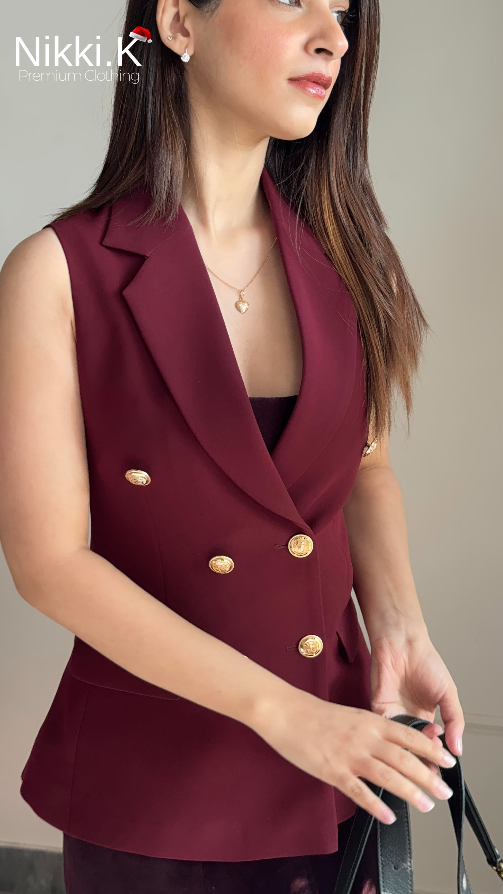 Woman wearing a sharp double breasted cherry burgundy wine waistcoat with gold buttons